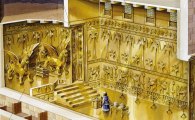 Temple interior matches olive wood doors covered in gold
